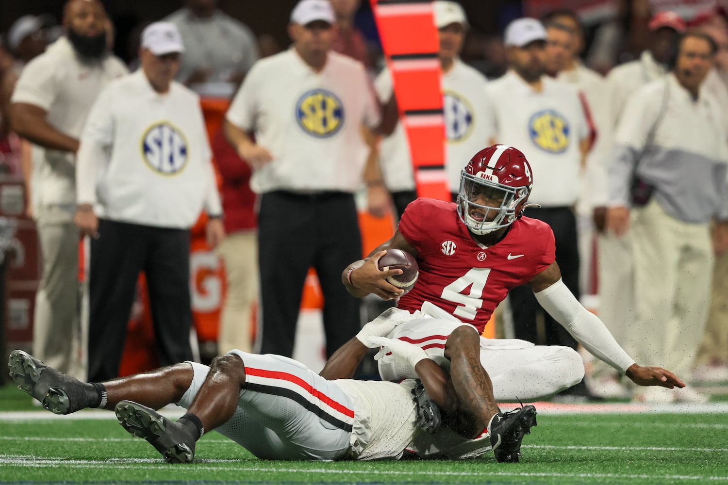 Georgia Bulldogs linebacker Jalon Walker (11) tackles Alabama Crimson Tide quarterback Jalen Milroe (4) during the first half of the SEC Championship football game at the Mercedes-Benz Stadium in Atlanta, on Saturday, December 2, 2023. (Jason Getz / Jason.Getz@ajc.com)