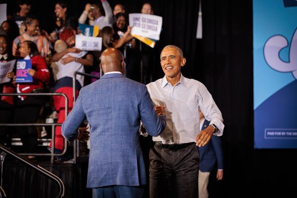 Former President Barack Obama greets U.S. Senator Raphael Warnock at a Democratic rally for gubernatorial candidate Stacey Abrams, Warnock, and other Democrats in Atlanta on Oct. 28, 2022.  (Arvin Temkar / arvin.temkar@ajc.com)