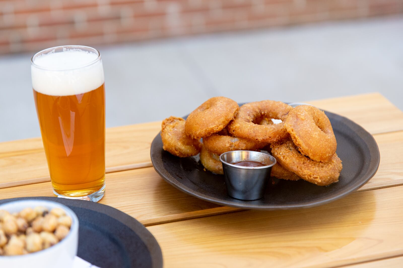 Biggerstaff Smoked Vidalia Onion Rings with house barbecue sauce and house dill dressing. (Mia Yakel for The Atlanta Journal-Constitution)