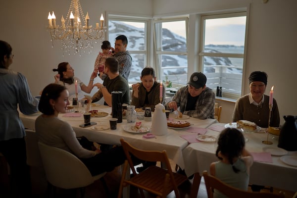 Relatives of Salik and Malu Schmidt gather to celebrate their weeding at their house in Nuuk, Greenland, Saturday, Feb. 15, 2025. (AP Photo/Emilio Morenatti)