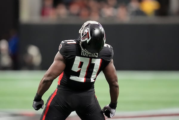 Atlanta Falcons defensive end Demone Harris (91) celebrates a sac against Los Angeles Chargers quarterback Justin Herbert (10) during the first half of an NFL football game on Sunday, Dec. 1, 2024 in Atlanta.(AP Photo/Mike Stewart)