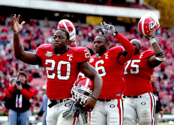 Seniors Thomas Brown (20), Kregg Lumpkin (6) and Fernando Velasco (75) wave goodbye and walk off the field together. This was their last game at Sanford Stadium.