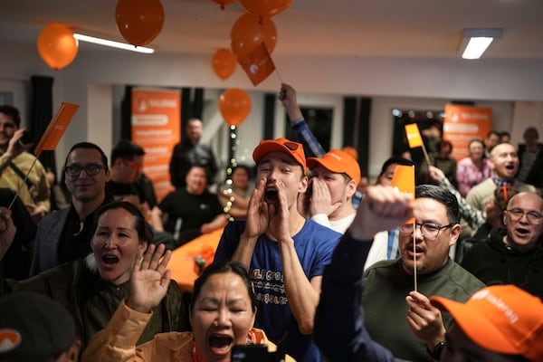 Members of the Naleraq party cheer during a party after parliamentary elections in Nuuk, Greenland, Tuesday, March 11, 2025. (AP Photo/Evgeniy Maloletka)