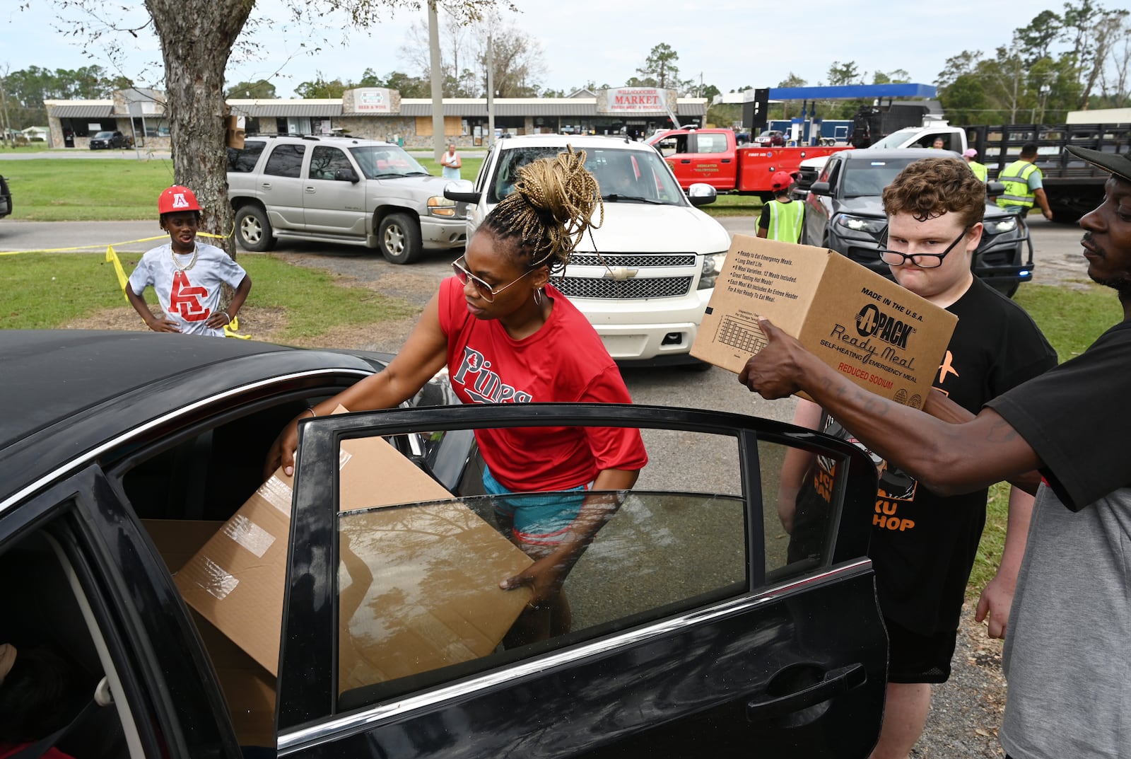 Volunteers hand out free meal kits, tarp and water as part of a Hurricane Helene relief effort in Willacoochee earlier this month.