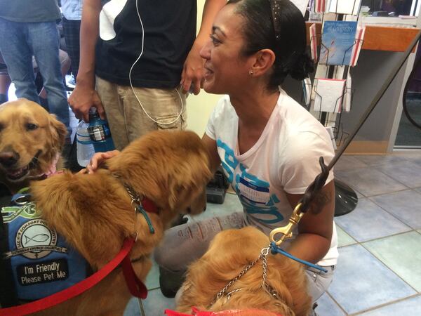 Luna Mendez is grieving for friends lost in the Pulse nightclub shootings and praying for others to recover. A visit from the Lutheran Church Charities K-9 Comfort Dogs was a healing moment for her. Photo: Jennifer Brett