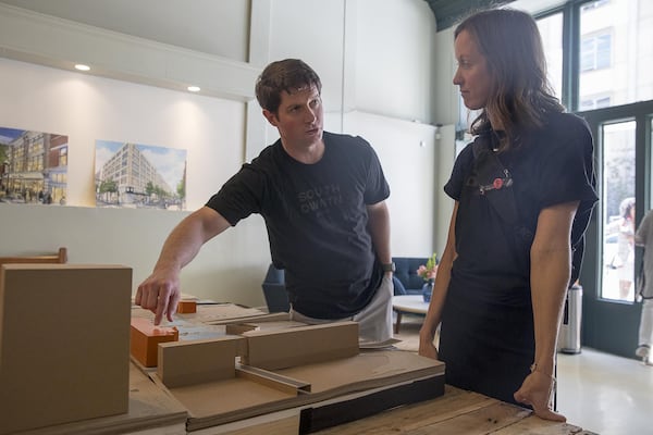 Jake Nawrocki (left), president of Newport US, and April Stammel (right), Newport US’s marketing vice president, discuss future development of Atlanta’s south downtown community during a “Pop-Up Row” shopping event along Mitchell Street. (ALYSSA POINTER/ALYSSA.POINTER@AJC.COM)