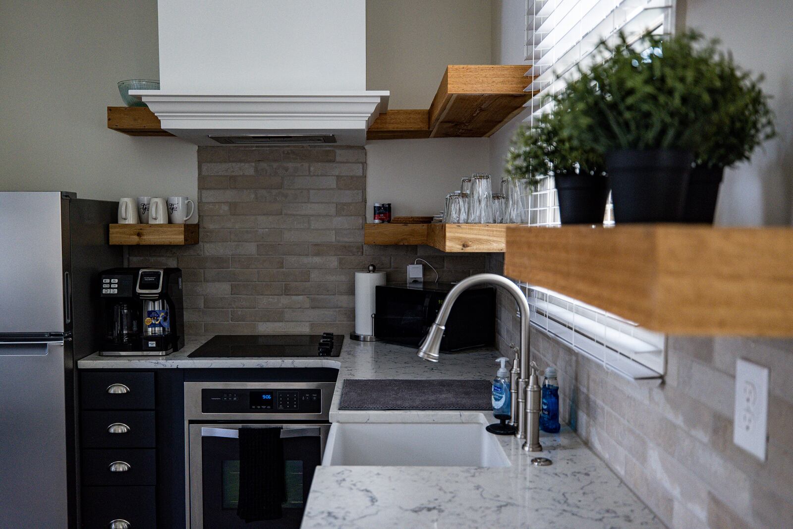 Look for smaller-scale appliances to help make your space feel bigger. Open shelving instead of upper cabinets will help a smaller kitchen feel more spacious. Photo: Courtesy of Trilith Micro Village