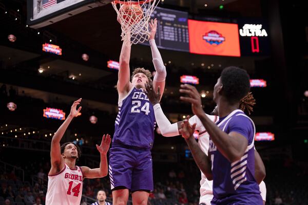 Grand Canyon forward Duke Brennan (24) shoots as Georgia forward Asa Newell (14) looks on during the first half of an NCAA college basketball game, Saturday, Dec. 14, 2024, in Atlanta. (AP Photo/Kathryn Skeean)