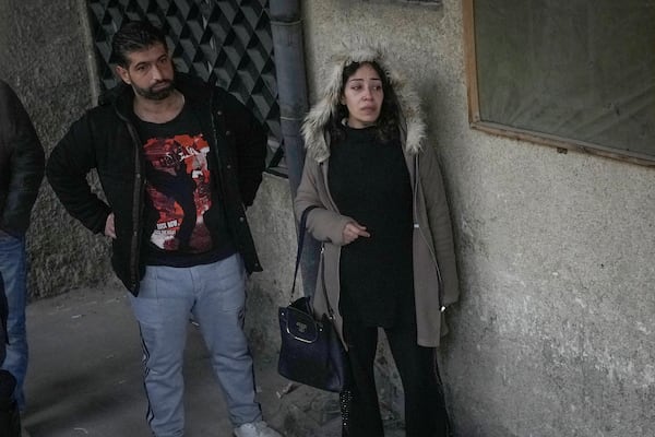 Mourners stand outside the morgue at the Al-Mojtahed Hospital in Damascus, Syria, Wednesday, Dec. 11, 2024. Many are flocking to morgues, hoping to identify loved ones who were either killed or imprisoned under President Bashar Assad's government, which collapsed over the weekend. (AP Photo/Hussein Malla)