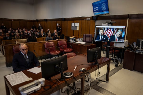 Attorney Emil Bove, left, listens as attorney Todd Blanche and President-elect Donald Trump, seen on a television screen, appear virtually for sentencing for Trump's hush money conviction in a Manhattan courtroom on Friday, Jan. 10, 2025 in New York. (Jabin Botsford/The Washington Post via AP, Pool)