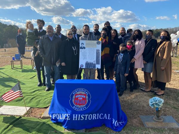 The family of Atlanta police Officer Claude Mundy Jr. stands at his gravesite last month on the 60th anniversary of his death. Mundy was among Atlanta's first Black police officers, and he was the first to be killed in the line of duty. (Credit: Shaddi Abusaid / shaddi.abusaid@ajc.com)