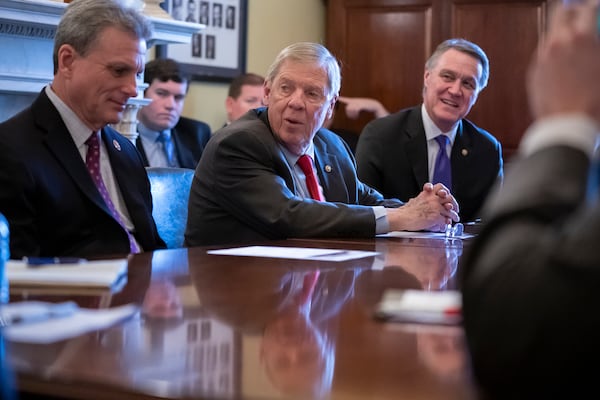 Sen. Johnny Isakson, R-Ga., flanked by Rep. Buddy Carter R-Ga., left, and Sen. David Perdue, R-Ga., right, leads a meeting with the Georgia Ports Authority and the Army Corps of Engineers to request full funding for the Savannah Harbor Expansion Project in the 2020 federal budget, on Capitol Hill in Washington, Thursday, Feb. 14, 2019. (AP Photo/J. Scott Applewhite)