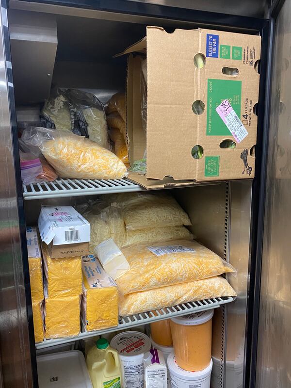 A cooler at VFC Kitchens is stocked with various cheeses needed to prepare menu items for nearly 40 virtual restaurants. Ligaya Figueras/ligaya.figueras@ajc.com