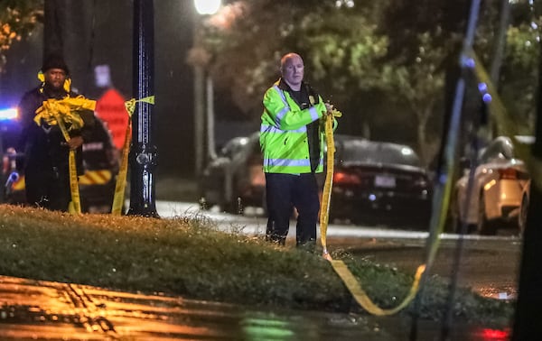 Atlanta police collect crime scene tape after investigating a deadly shooting Monday morning in the 500 block of Bishop Street in West Midtown.