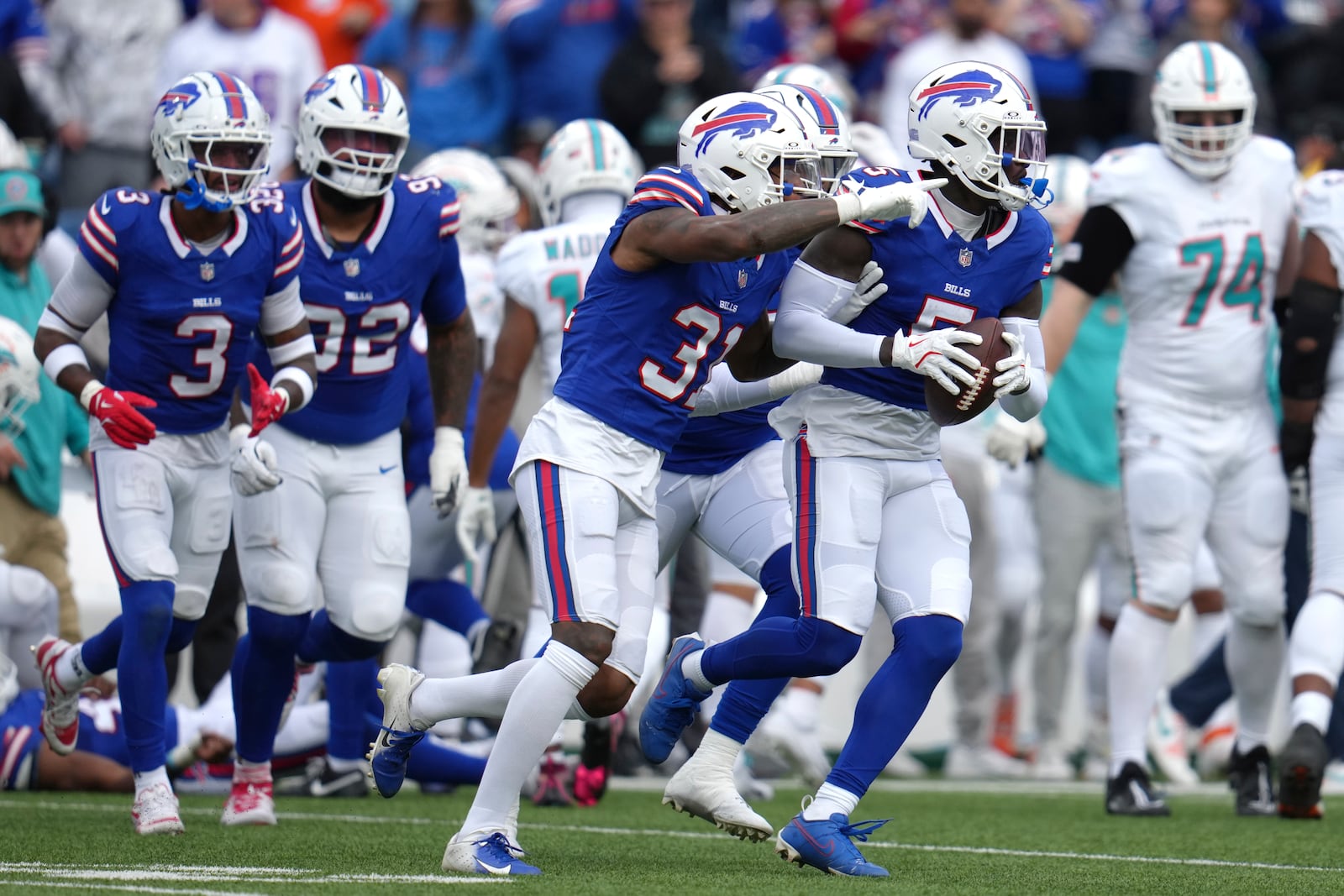 Buffalo Bills cornerback Rasul Douglas (31) and cornerback Kaiir Elam (5) celebrate after the Bills recovered a fumble by Miami Dolphins running back Raheem Mostert during the second half of an NFL football game Sunday, Nov. 3, 2024, in Orchard Park, N.Y. (AP Photo/Gene Puskar)