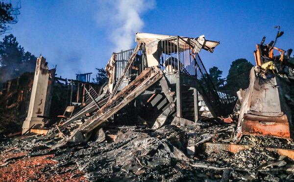 A charred building at the Ashford at Stoneridge Apartments was still smoldering Thursday morning more than 12 hours after fire broke out at the complex. According to the Red Cross, 38 people lost their homes.