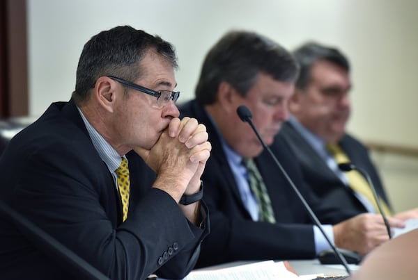 Commissioner Tim Echols, left, listens during a Georgia Public Service Commission meeting in December 2017. Hyosub Shin / hshin@ajc.com