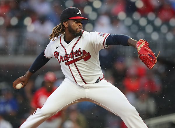 Braves starting pitcher Touki Toussaint delivers against the Cincinnati Reds during the first inning Wednesday, Aug. 11, 2021, in Atlanta.   (Curtis Compton / Curtis.Compton@ajc.com)