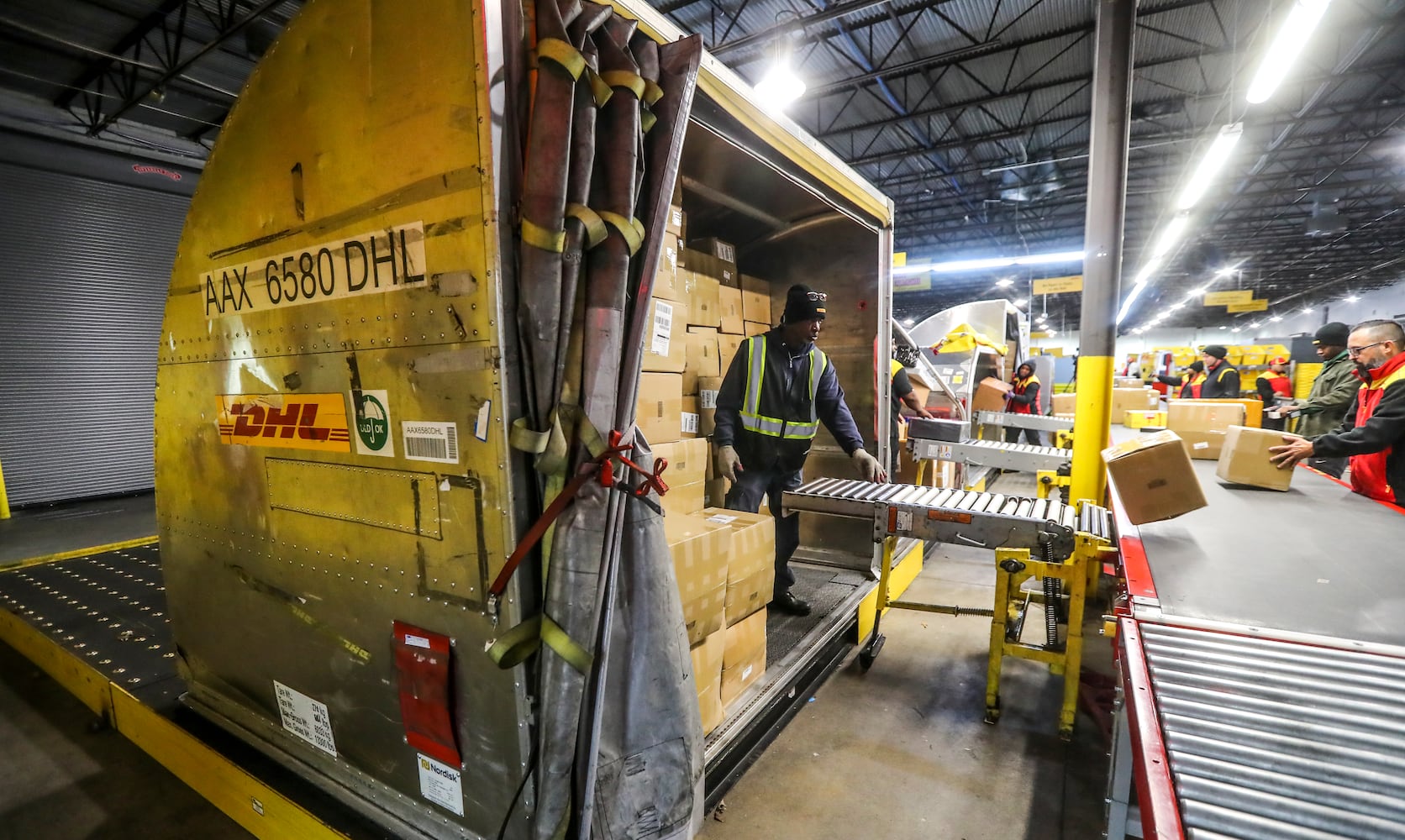 December 15, 2022 ATLANTA: Tony Glass unloads the big plane carton for sorting. (John Spink / John.Spink@ajc.com)

