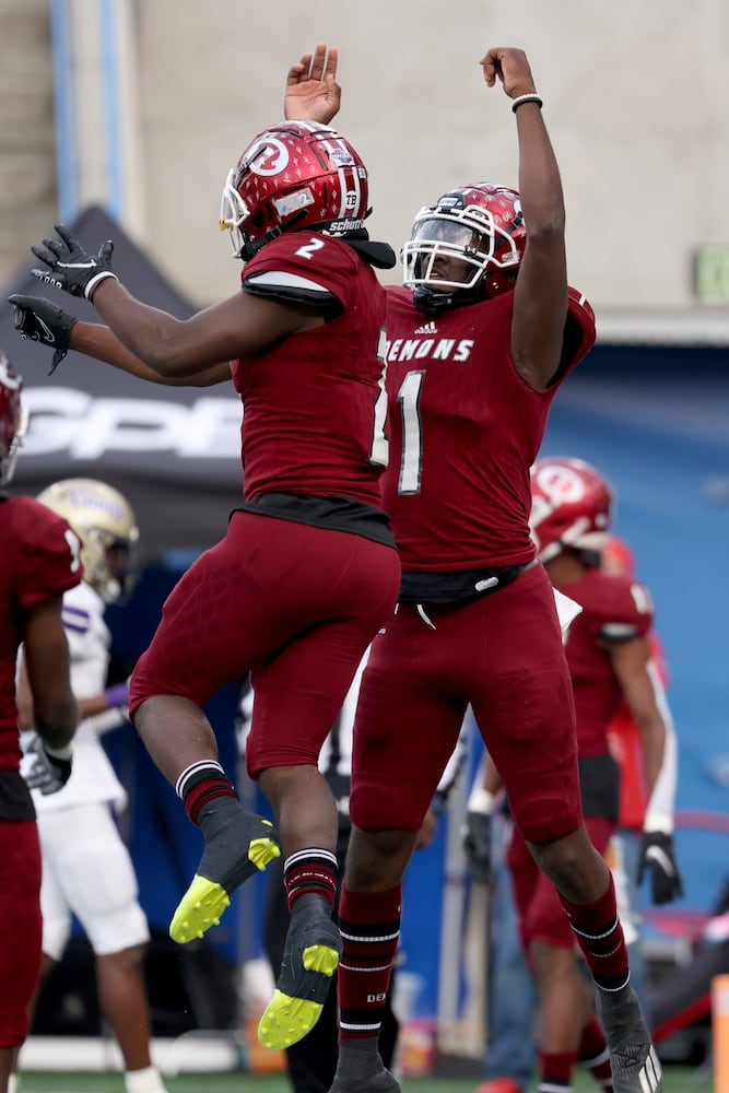 Warner Robins quarterback Jalen Addie (1) celebrates a rushing touchdown with running back Jahlen Rutherford, left, in the first half against Cartersville during the first half of their Class 5A state high school football final at Center Parc Stadium Wednesday, December 30, 2020 in Atlanta. JASON GETZ FOR THE ATLANTA JOURNAL-CONSTITUTION