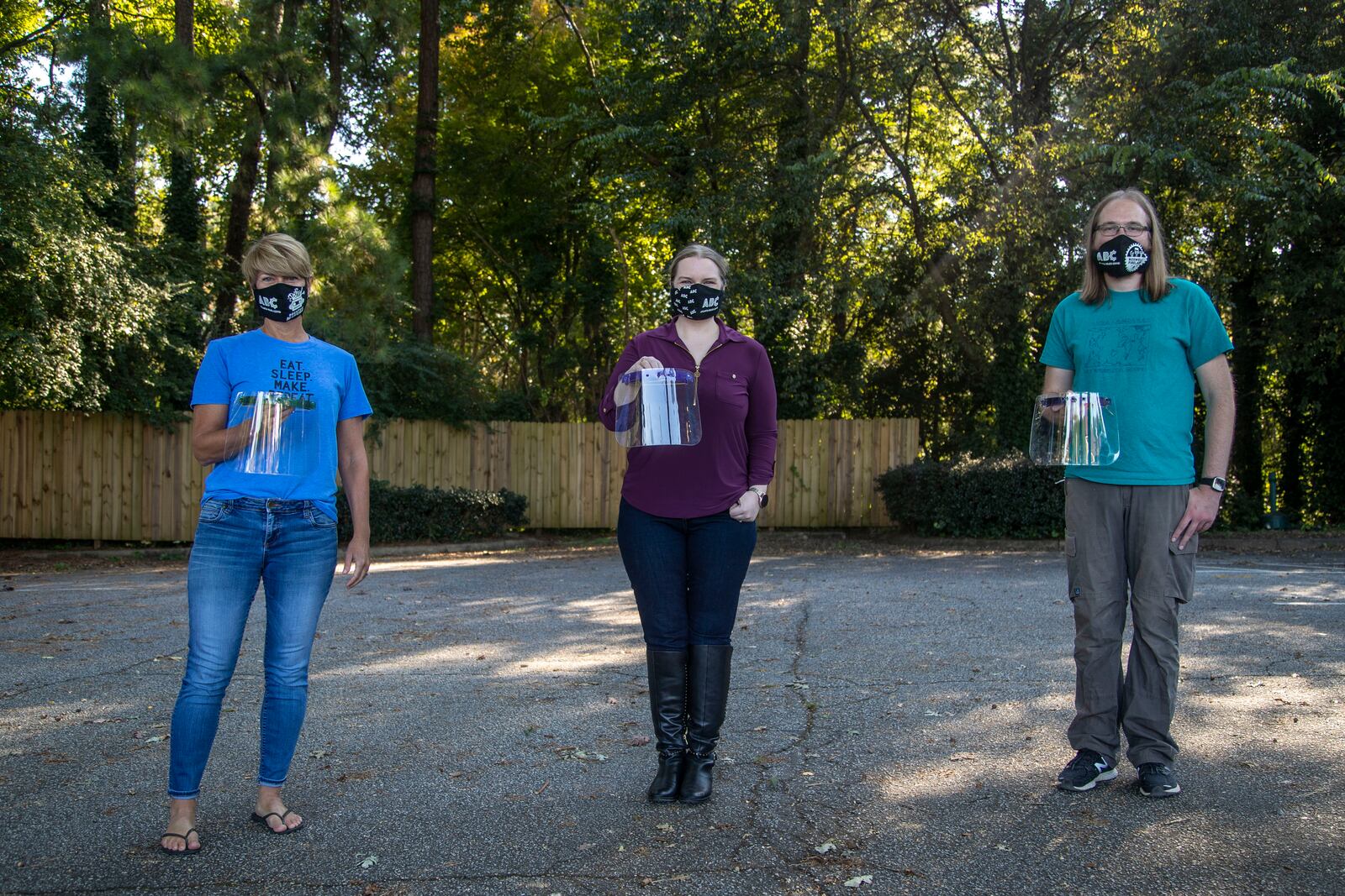 10/6/2020 - Roswell, Georgia - Irm Diorio (left), director of Decatur Makers, Skyler Holobach (center), co-founder of Atlanta Shield Makers and William Strika (right), executive director of Roswell Firelabs, pose with face shields they created at Roswell Firelabs in Roswell, Tuesday, October 6, 2020. (Alyssa Pointer / Alyssa.Pointer@ajc.com)