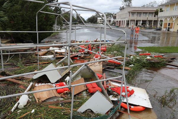 September 11, 2017 St. Marys: Local residents Gary McClain (left) and Bill Gross take in the remains of the old Cumberland Island Ferry scattered across a flooded street after Hurricane Irma swept through taking out the cityâs docks, damaging homes and sinking numerous boats on Monday, September 11, 2017, in St. Marys. Most of the ferry sank to the bottom. Many residents said it was the worse damage in the city they had ever seen.   Curtis Compton/ccompton@ajc.com