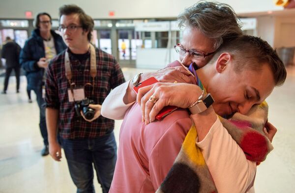 JJ Warren of New York embraces Julie Arms Meeks of Atlanta during protests outside the United Methodist Church's 2019 Special Session of the General Conference in St. Louis in  February 2019. The United Methodist Church faces a likely surge in defections and defiance after delegates at a crucial conference voted to strengthen bans on same-sex marriage and ordination of LGBT clergy. (AP Photo/Sid Hastings)