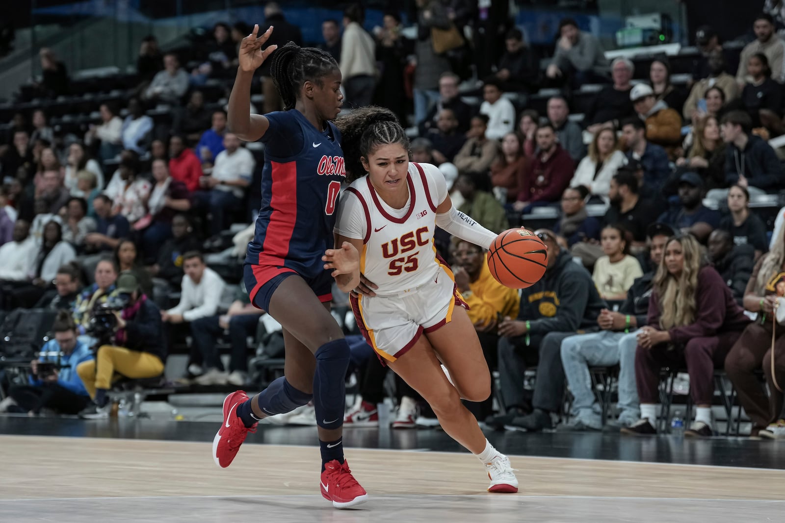 USC Trojans's guard Talia von Oelhoffen, right, competes for the ball against Ole Miss's guard Sira Thienou, left, during the basketball match between the University of Southern California (USC) and Ole Miss, Monday, Nov. 4, 2024 in Paris, France. (AP Photo/Aurelien Morissard)