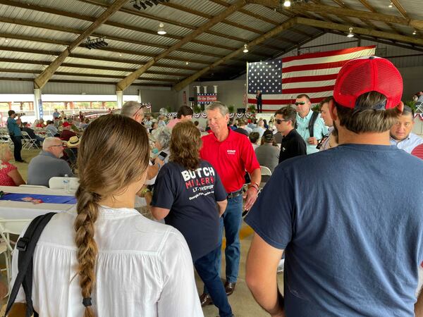 Gov. Brian Kemp (in red shirt) speaks to well-wishers at a state GOP rally in Floyd County on Saturday, August 7, 2021. (Photo: Greg Bluestein/AJC)