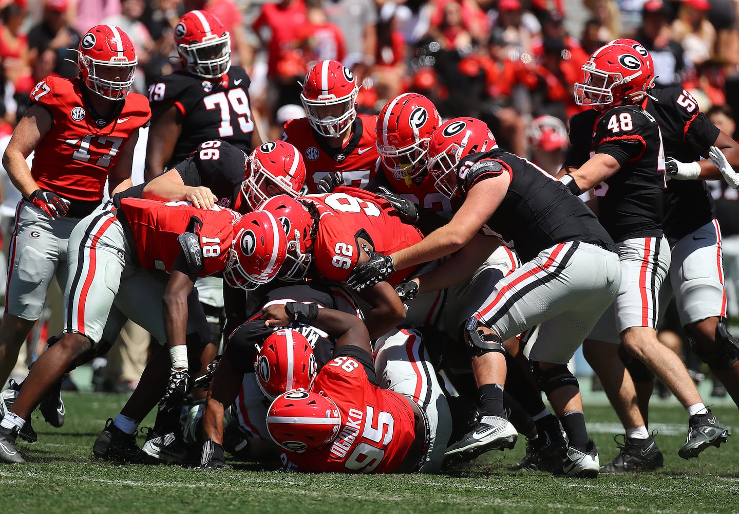 Georgia defenders smother running back Brandon Mathis after  a short gain during the G-Day game on Saturday, April 13, 2024.  Curtis Compton for the Atlanta Journal Constitution