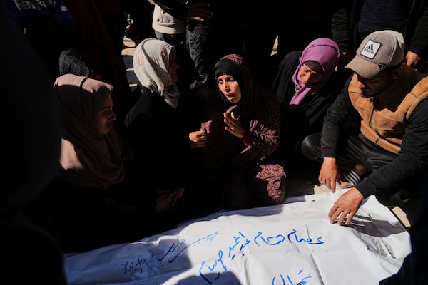 Mourners gather around the bodies of their relatives killed in the Israeli bombardment of the Gaza Strip as they are brought for burial at Nasser Hospital in Khan Younis, Sunday, March 23, 2025. (AP Photo/Abdel Kareem Hana)