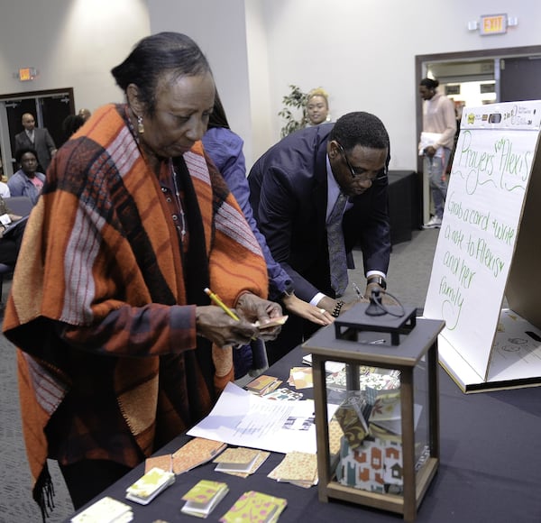 Clark Atlanta University interim provost Dorcas Bowles and assistant provost Calvin L. Brown join students and others in writing words of comfort for the family of Alexis Crawford on Nov. 10. 