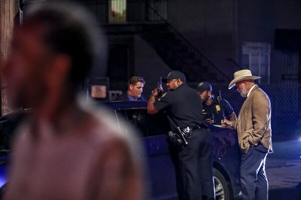 Homicide detective Al Hogan (right) gathers evidence at the scene of a deadly 2021 shooting in northwest Atlanta.
 (John Spink / John.Spink@ajc.com)


