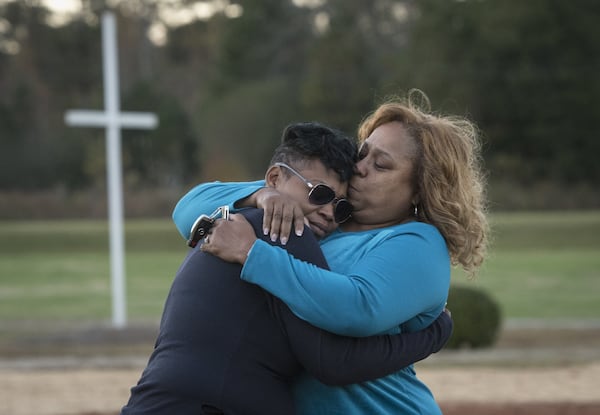 Akiyoshi Metts, left, is comforted by her aunt Carla Butler, at the site of her mother’s grave on her mother’s birthday, Monday, Nov.13, 2017 in in Palmetto, Ga. 