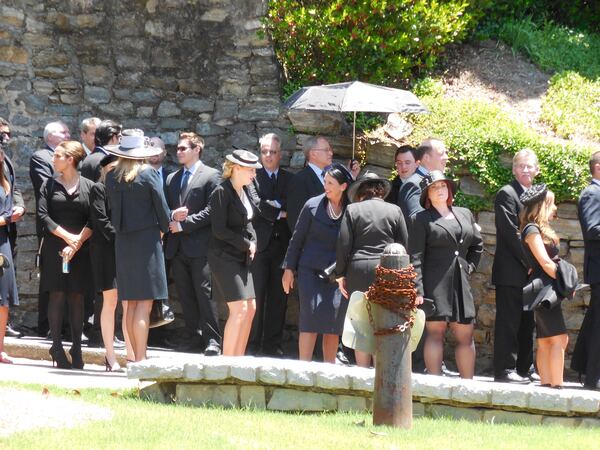 A funeral scene for "Captain America: Civil War" filmed at Peachtree Christian Church the other day. Dark clothing and a sunny day made things a little warm for the extras. Looks like someone thought ahead and brought an umbrella for some shade. Photo: Jennifer Brett