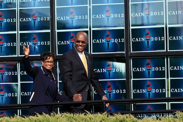 Herman Cain, as a Republican presidential candidate, approaches the stage with his wife, Gloria, to speak at a campaign event in Atlanta on Dec. 3, 2011. Cain, a former business executive who was recently hospitalized with the coronavirus, has died, current and former employees confirmed Thursday. He was 74. (Philip Scott Andrews/The New York Times)