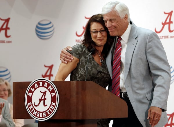 FILE - Athletic Director Bill Battle gives Dana Duckworth a hug as she addresses the media about her appointment as head coach of the University of Alabama gymnastics team during a news conference in the Mal M. Moore Athletic Building, July 15, 2014, in Tuscaloosa, Ala. (Erin Nelson/The Tuscaloosa News via AP, File)