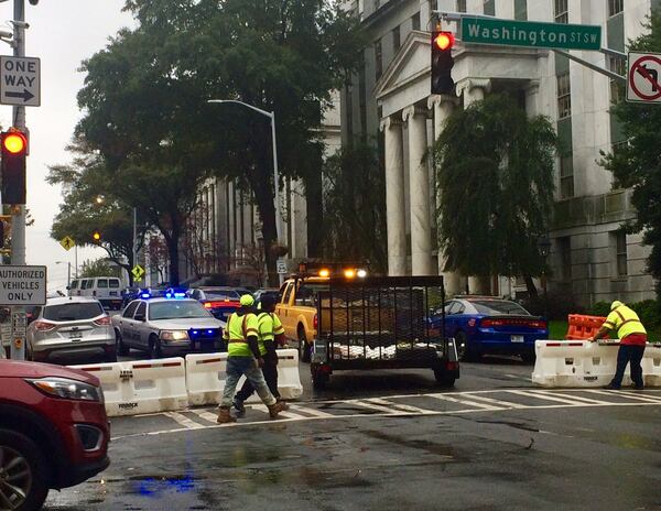 Georgia Department of Transportation crews work to close off Mitchell Street by the Capitol. 