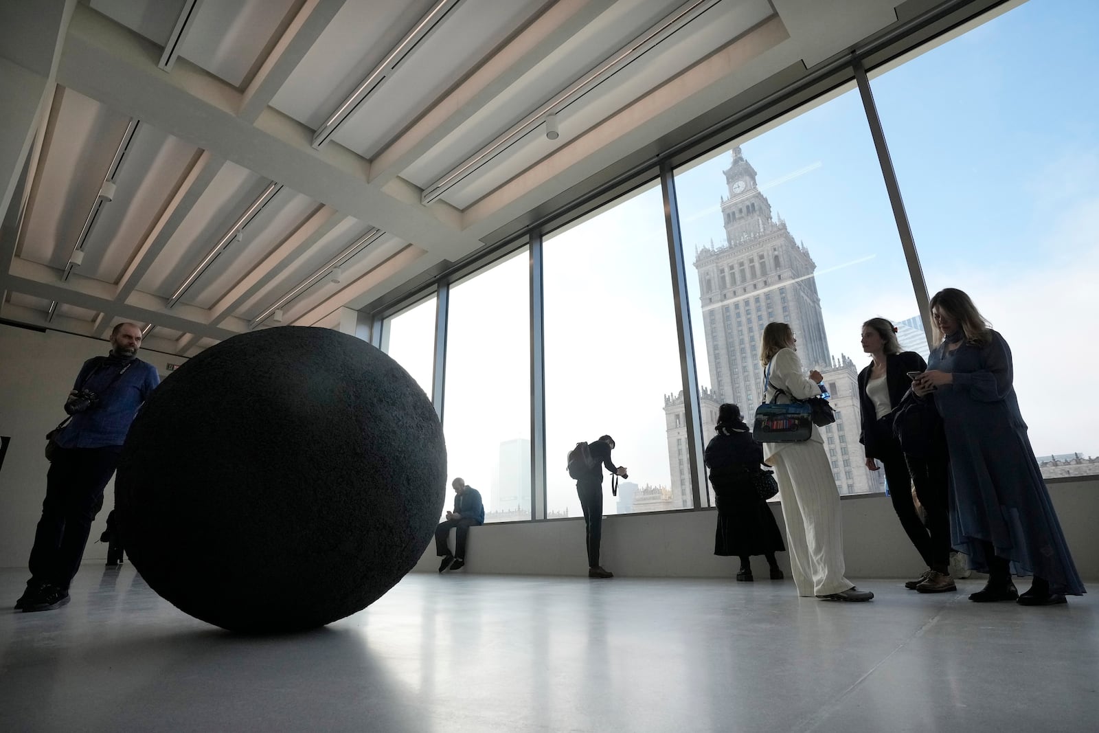 People look out of the window of the Museum of Modern Art in Warsaw, Poland, on Thursday Oct. 24, 2024. (AP Photo/Czarek Sokolowski)