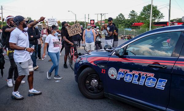 June 13, 2020 -  Atlanta -  Protestors gather at University Ave. at the Atlanta Wendy's where Rayshard Brooks, a 27-year-old Black man,  was shot and killed by Atlanta police Friday evening during a struggle in a Wendy's drive-thru line.    Ben Gray for the Atlanta Journal Constitution