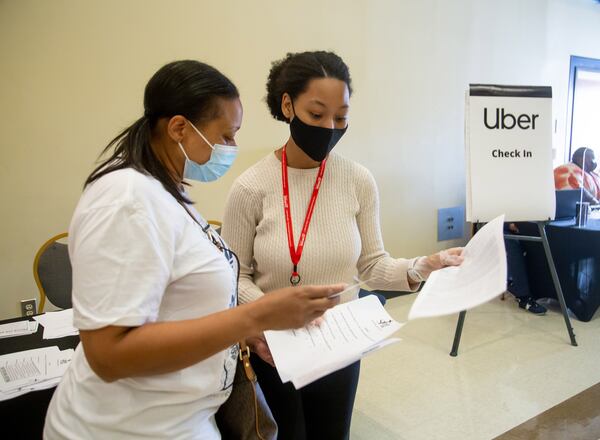 Volunteer Morgan Hodge helps Terri Fleming with her paperwork after Hodge received her vaccination shot at St. Philip AME Church in Atlanta Saturday, March 13, 2020. (Steve Schaefer for The Atlanta Journal-Constitution)