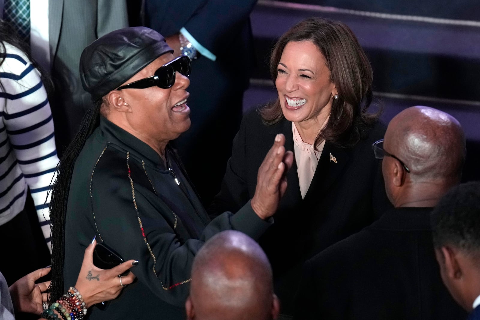 Democratic presidential nominee Vice President Kamala Harris, right, and Stevie Wonder attend a church service and early vote event at Divine Faith Ministries International, Sunday, Oct. 20, 2024, in Jonesboro, Ga. (AP Photo/Jacquelyn Martin)