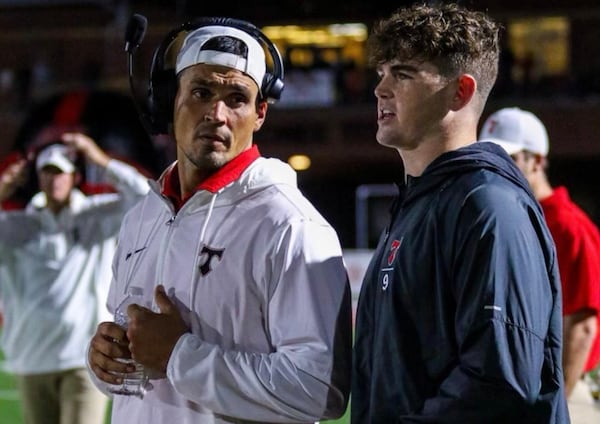 David Pollack, left, here with North Oconee High football player and Army commit Jack Kelly, will be coaching the Titans' defensive linemen in a Class 4A playoff game Saturday afternoon instead of sitting on the set with the ESPN "College GameDay" crew as he did the previous 11 years. Pollack's contract with ESPN was not renewed this in a massive talent layoff. But he has kept close tabs on his Georgia Bulldogs and the college football landscape during his hiatus this year. (Special Photo)