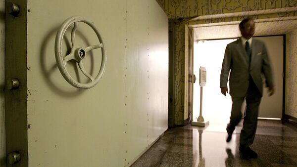 WHITE SULPHUR SPRINGS, WV - JULY 14:  A resort employee passes by the Hotel Blast Door, which weighs 18 tons and serves as an entrance to a former government relocation facility, also know as "the bunker," at Greenbrier Resort July 14, 2006 in White Sulphur Springs, West Virginia. The bunker, codenamed "Project Greek Island" and planned by the Eisenhower Administration, was a 112,000 square-foot shelter constructed beneath the Greenbrier Resort's West Virginia Wing, to serve as a relocation site for members of the U.S. Congress and associated staff in the event of a nuclear attack on the U.S. soil. The facility was built between 1958 and 1961 and was maintained in a state of operational readiness until the government terminated the lease with the resort in 1995. The bunker will be reopened for public tours on August 20 after a two-year-long renovation.  (Photo by Alex Wong/Getty Images)