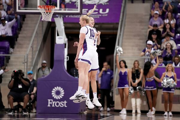 TCU's Hailey Van Lith (10) and Madison Conner, rear, celebrate after a basket by Conner in the first half of an NCAA college basketball game against Houston in Fort Worth, Texas, Wednesday, Feb. 26, 2025. (AP Photo/Tony Gutierrez)