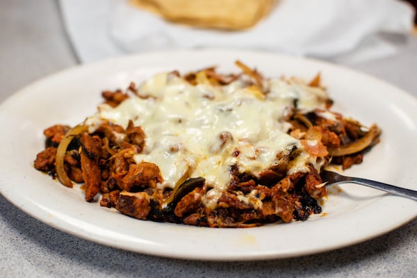 The pastor parillada at La Pastorcita features al pastor pork chopped up with ham, mushroom, onions and cheese. CONTRIBUTED BY HENRI HOLLIS