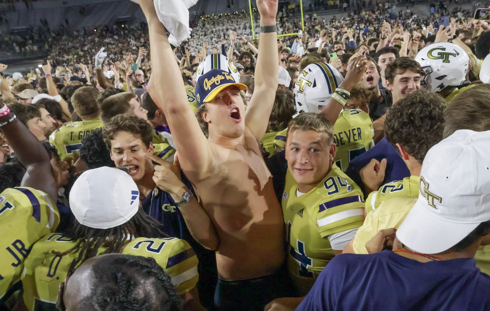 Georgia Tech players celebrate their win over North Carolina and fans storm the field fter a NCAA football game In Atlanta on Saturday, Oct. 28, 2023 between the Georgia Tech Yellow Jackets and the North Carolina Tar Heels.  Georgia Tech won, 46-42.  (Bob Andres for the Atlanta Journal Constitution)