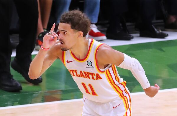 Hawks guard Trae Young reacts to hitting a three pointer against the Milwaukee Bucks during a 116-113 victory in Game 1 of the Eastern Conference finals Wednesday, June 23, 2021, in Milwaukee. (Curtis Compton / Curtis.Compton@ajc.com)