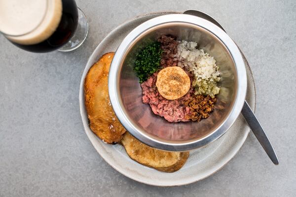 The Dry Aged Beef Tartare with Russian dressing and caraway vinegar is mixed tableside at Cold Beer. CONTRIBUTED BY MIA YAKEL