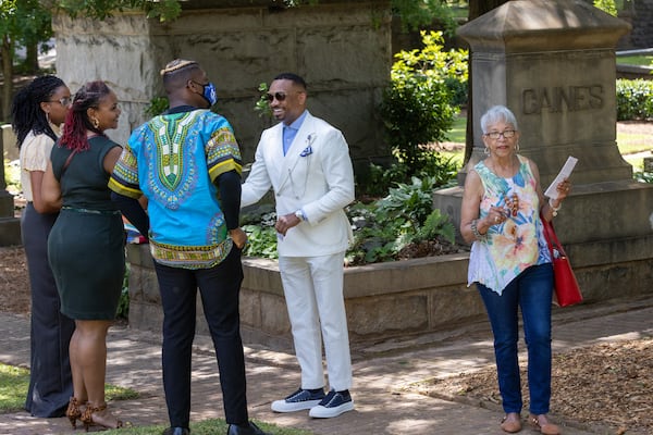 Morris Brown College President Kevin James (center) talks with people after the Historic Oakland Foundation ceremony for the newly restored African American Burial Grounds at Oakland Cemetery on Friday, June 10, 2022. (Steve Schaefer / steve.schaefer@ajc.com)